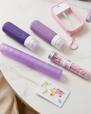 Purple travel kit – 2 silicon bottles, 1 perfume or mist spray bottle, 1 tooth brush holder, 1 watermelon soap paper bottle, 1 travel tag